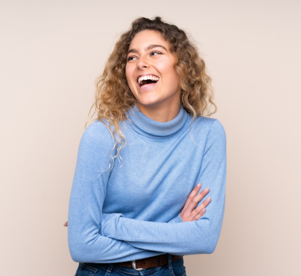 woman smiling in the light brown background